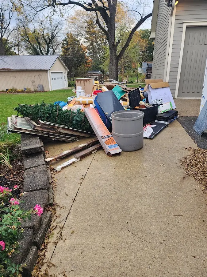 Dumpster being loaded with debris for Commercial Dumpster Rental in Springdale